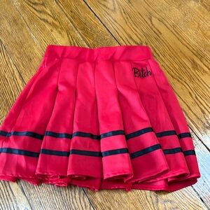 Spencers red pleated “cheerleader” skirt.  Black trim logo B***CH.  Medium